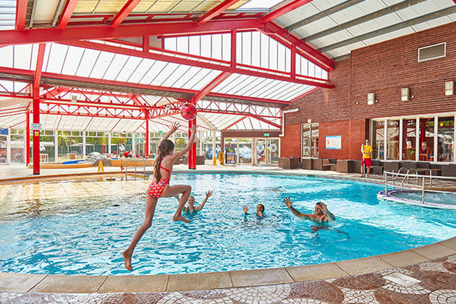 kid jumping into swimming pool