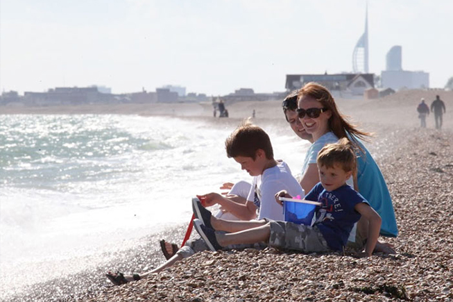 family on the beach sitting